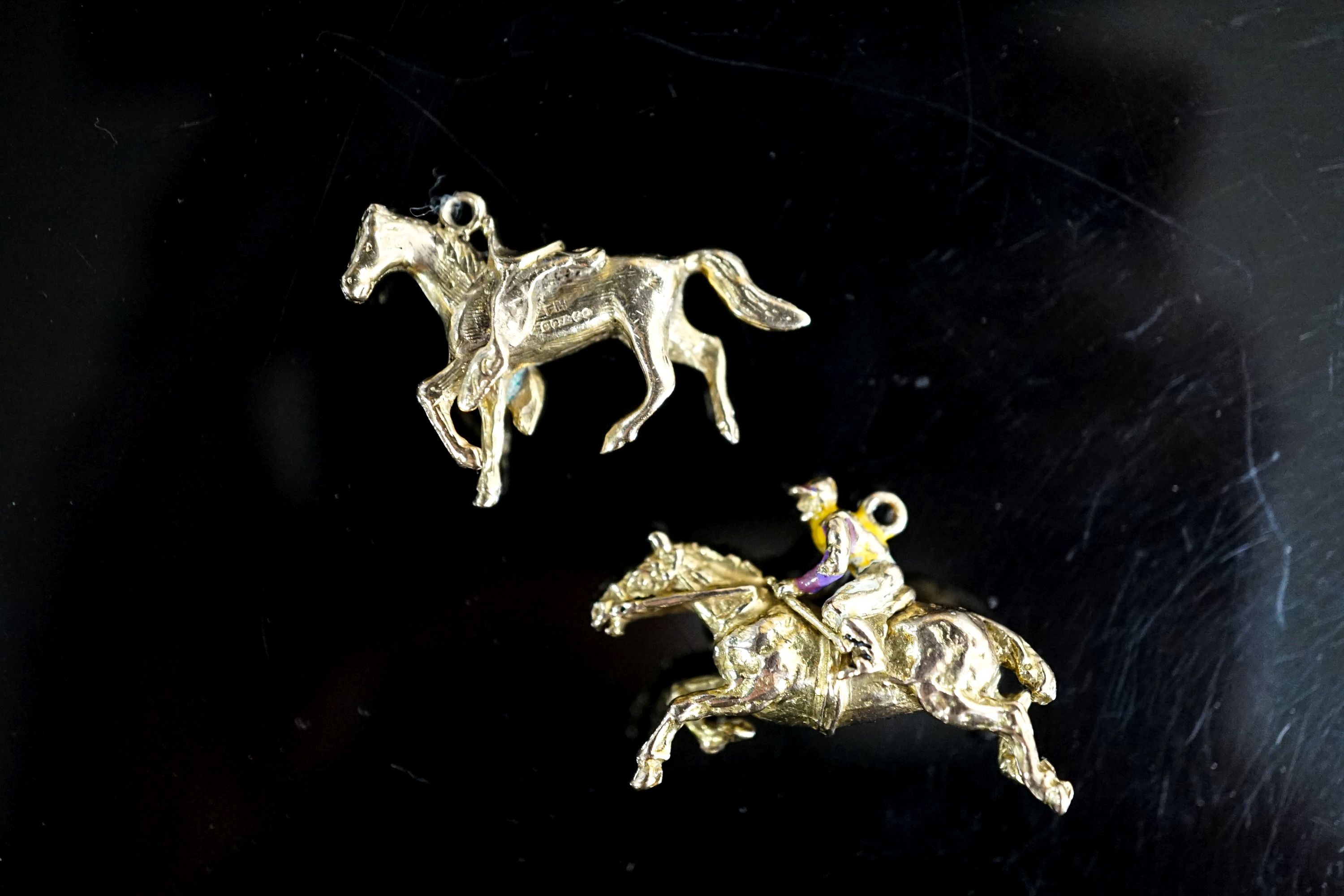 Two 9ct gold horse pendant charms including enamelled horse and jockey(a.f.), 33mm, gross 14.7 grams.